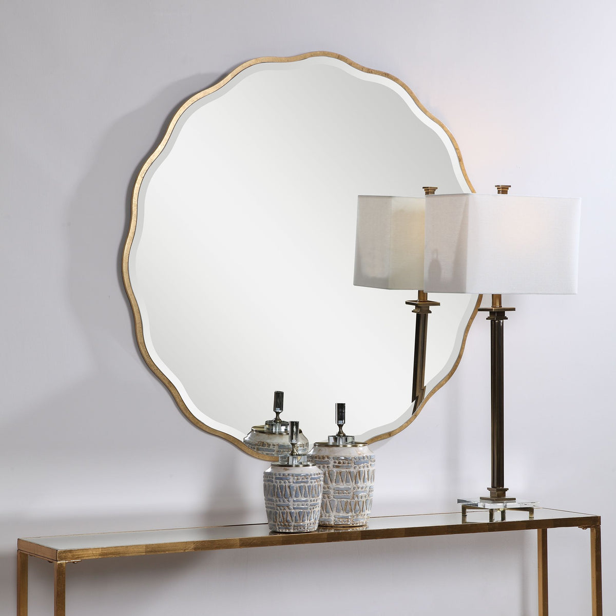Aneta Gold round mirror with a metallic gold frame.