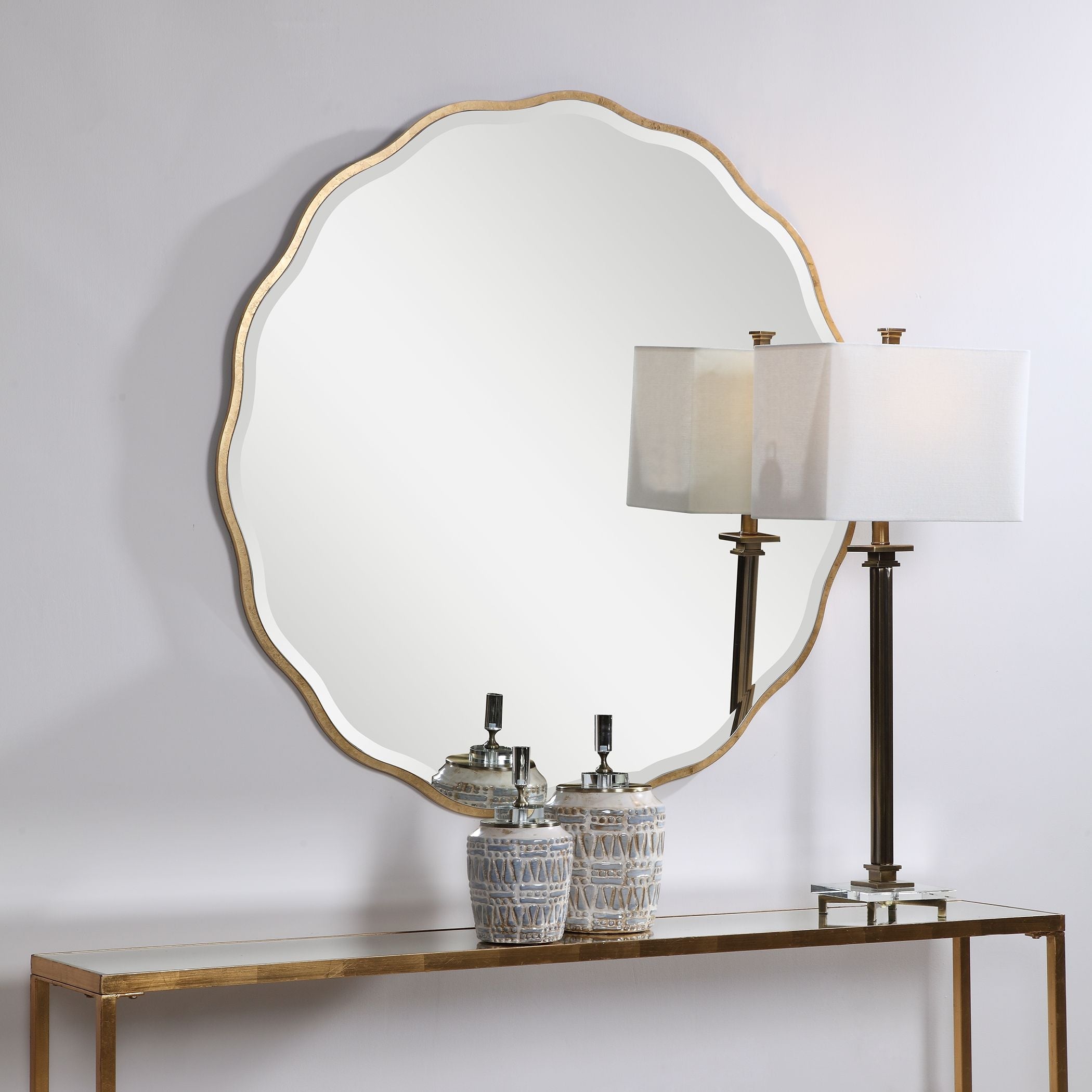 Aneta Gold round mirror with a metallic gold frame.