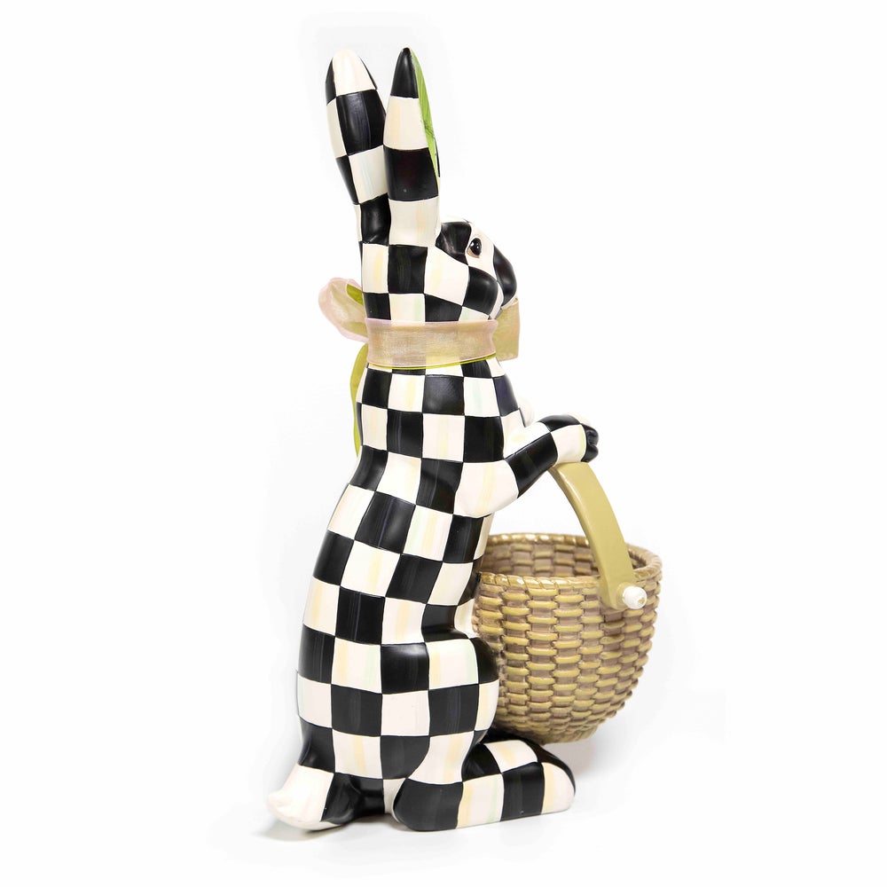 Black and white checkered resin rabbit figurine holding a small woven basket.