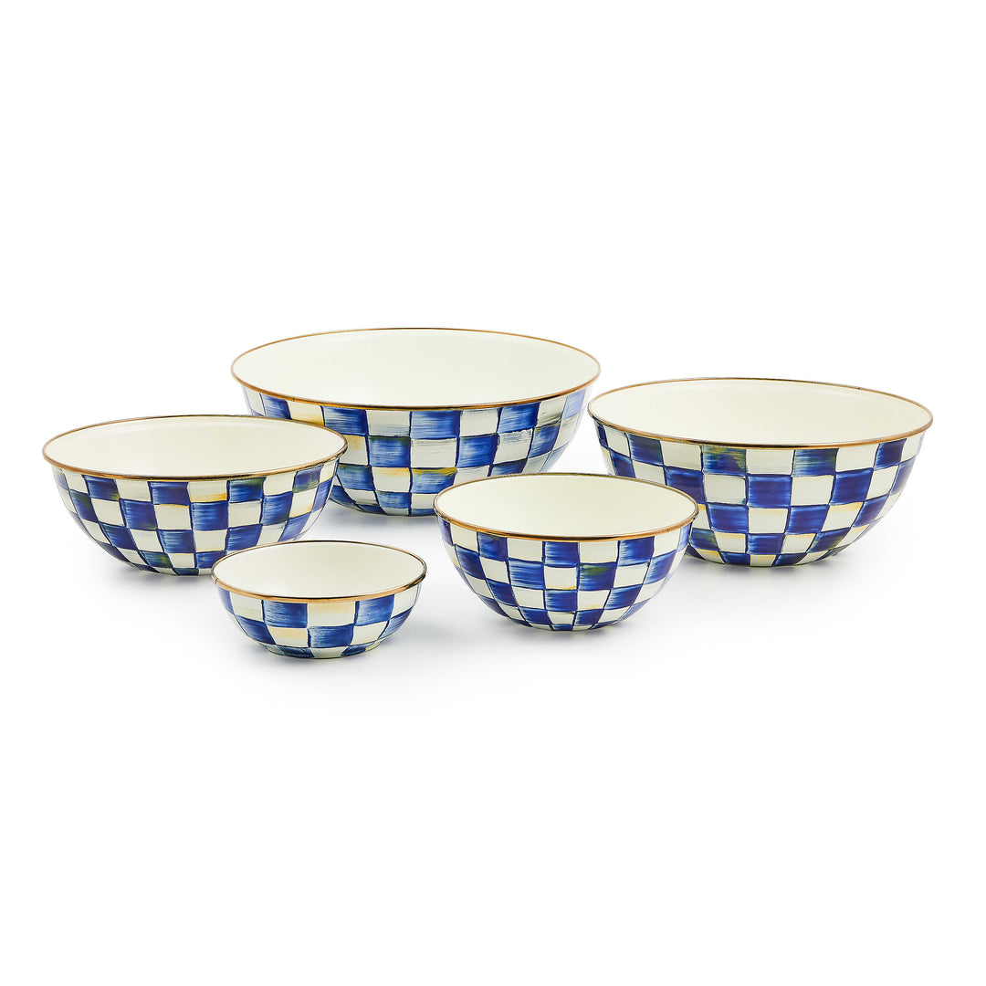 Set of five hand-painted blue and white checkered enamel bowls in varying sizes with bronze rims.