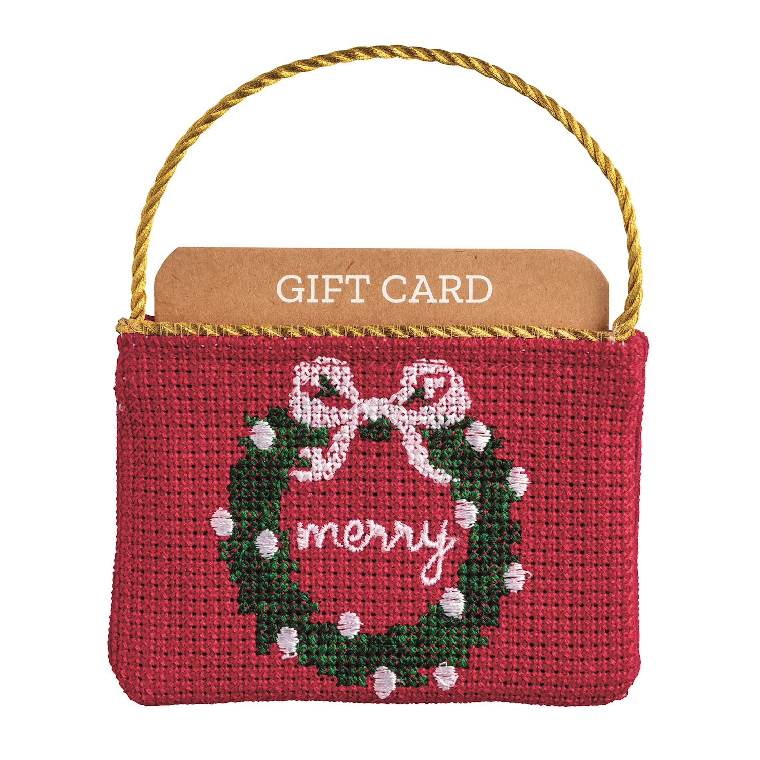 Red needlepoint gift card pouch with a green wreath, white bow, and 'merry' text.