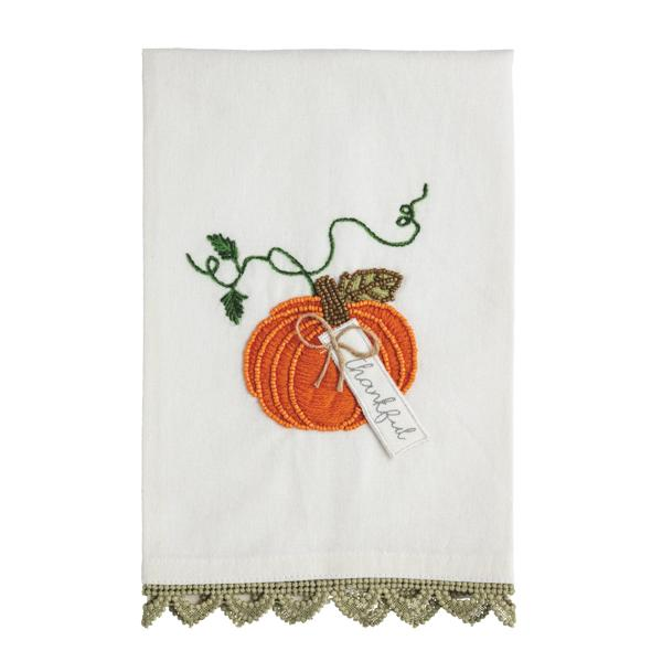 White cotton towel with a beaded orange pumpkin embroidery, a 'thankful' tag, and crochet trim.