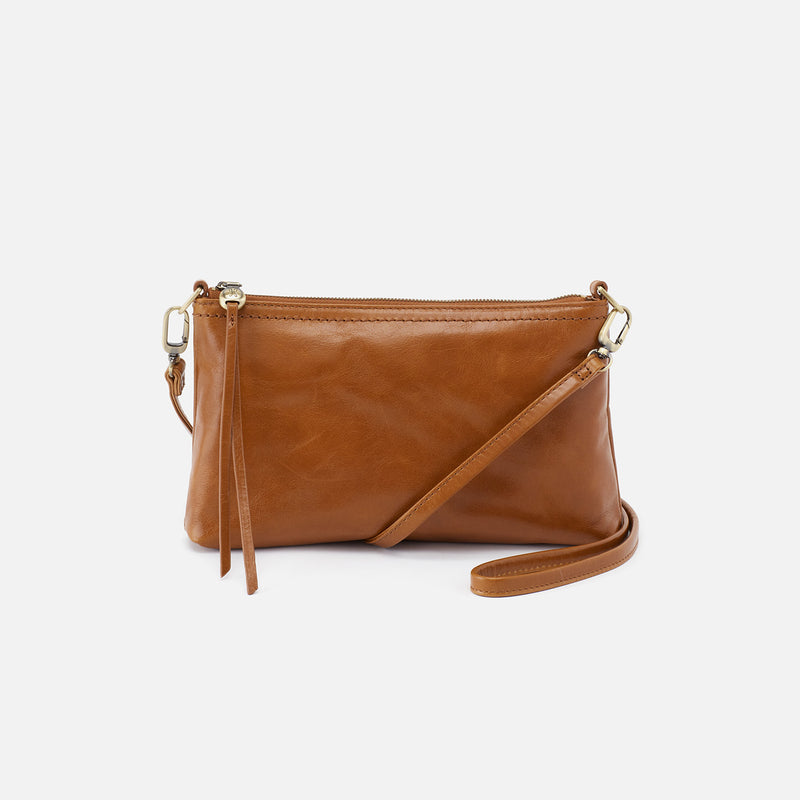 Darcy crossbody bag in solid leather with antique brass hardware, featuring a zip closure and convertible strap.