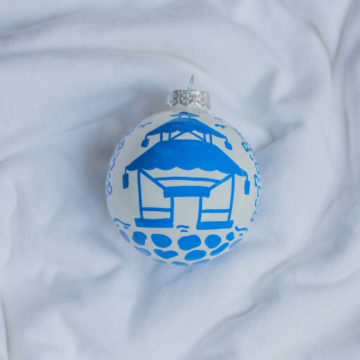 Hand-painted pagoda scene ornament with intricate architectural silhouettes in earth tones.
