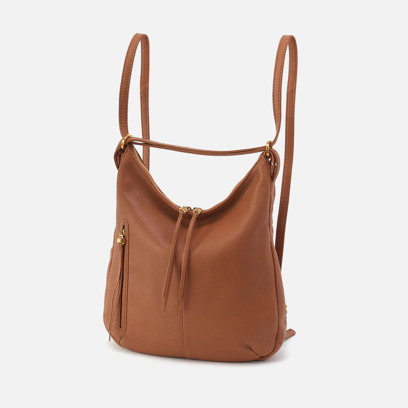 Merrin Convertible Backpack in Warm Honey pebbled leather with brass hardware and double straps.