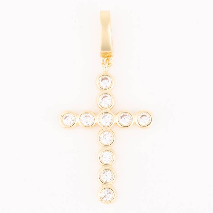 Gold cross charm with circular bezel-set clear stones and a polished bail.