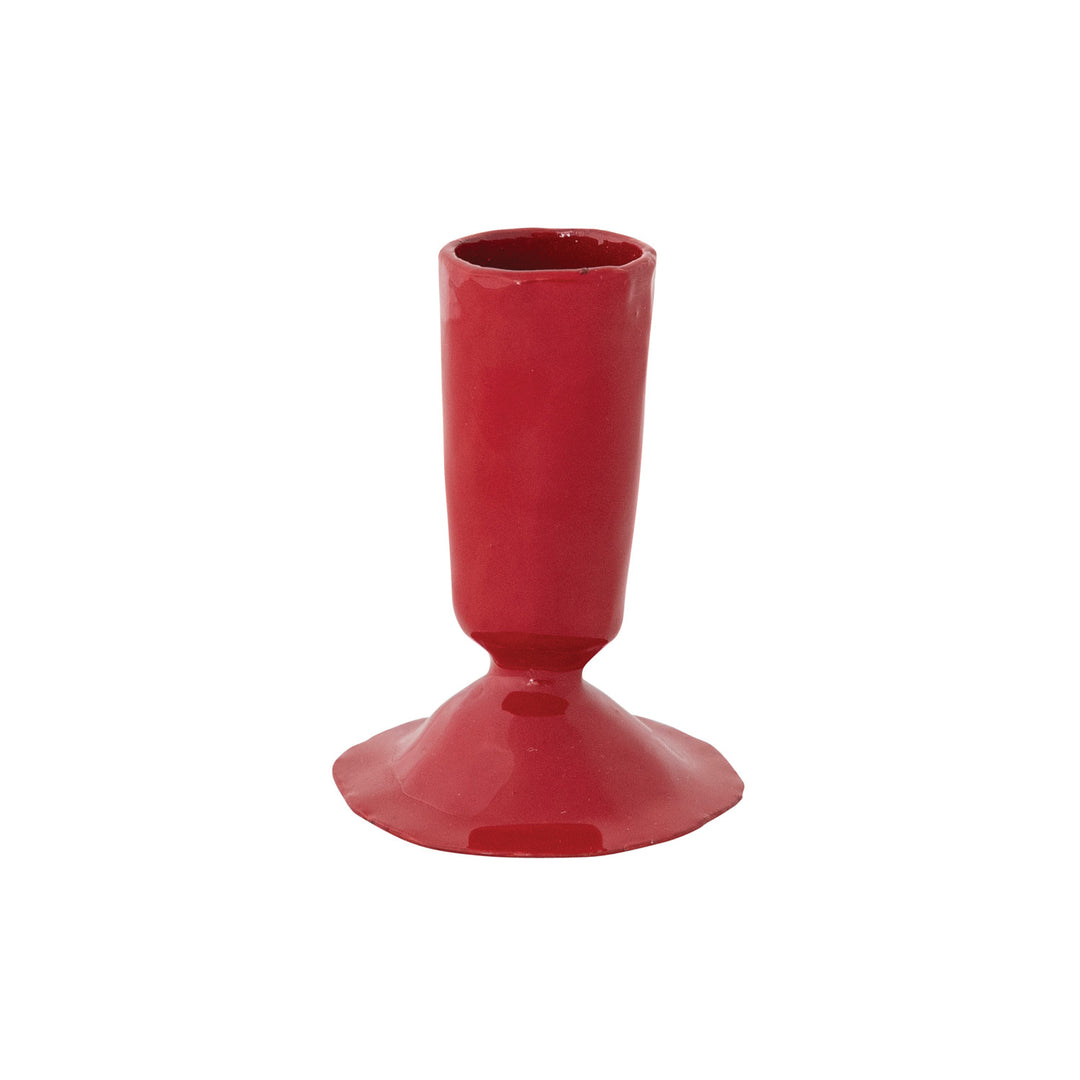 Hand-forged red enameled cast iron taper candle holder with a wide base and cylindrical top.