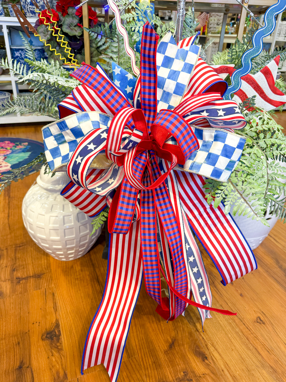 Patriotic bow with red, white, and blue stripes, stars, and checkered patterns.