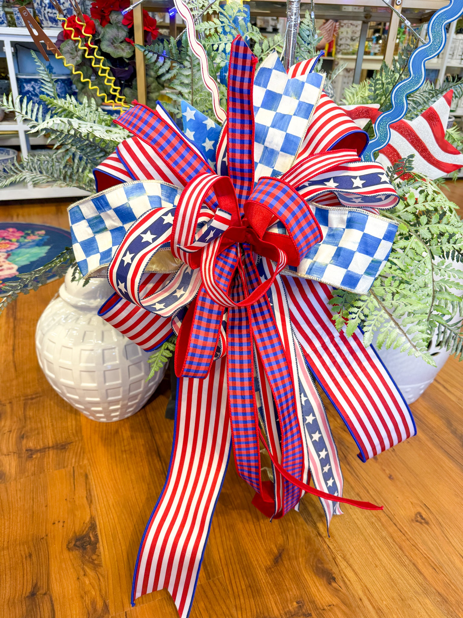 Patriotic bow with red, white, and blue stripes, stars, and checkered patterns.