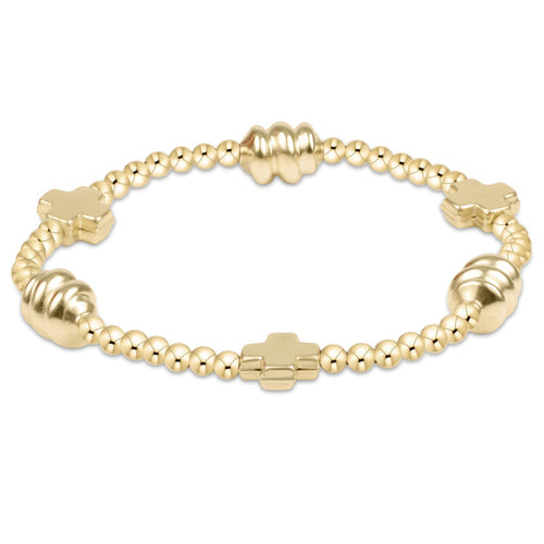 Gold beaded bracelet with 3mm beads, three signature crosses, and three ribbed admire beads.