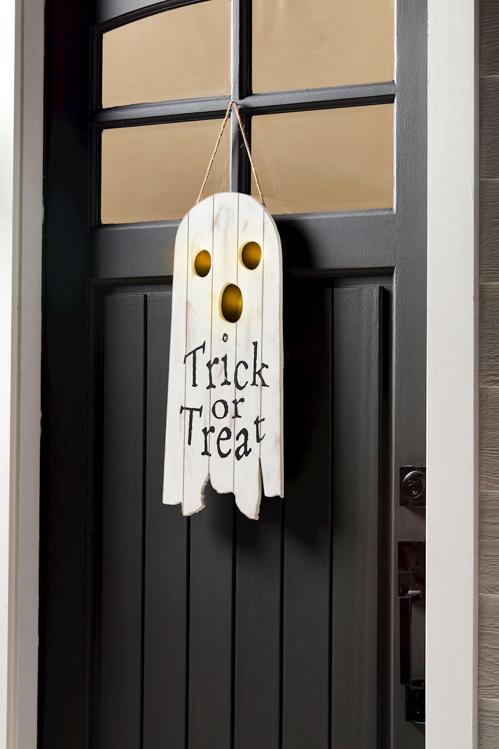 Pine wood door hanger shaped like a ghost with integrated light-up features.