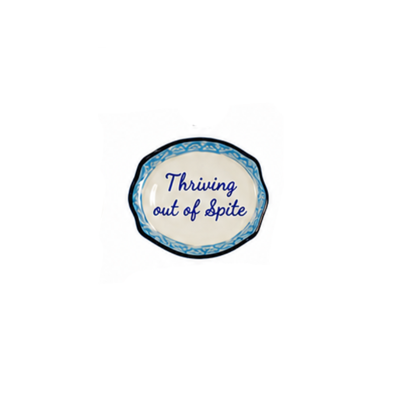 Hand-painted stoneware magnet shaped like a mini plate with script reading "Thriving out of Spite".