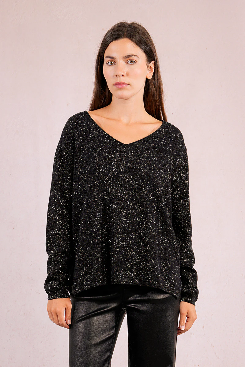 Woman wearing the Lesli black V-neck knitted sweater with gold metallic flecks.