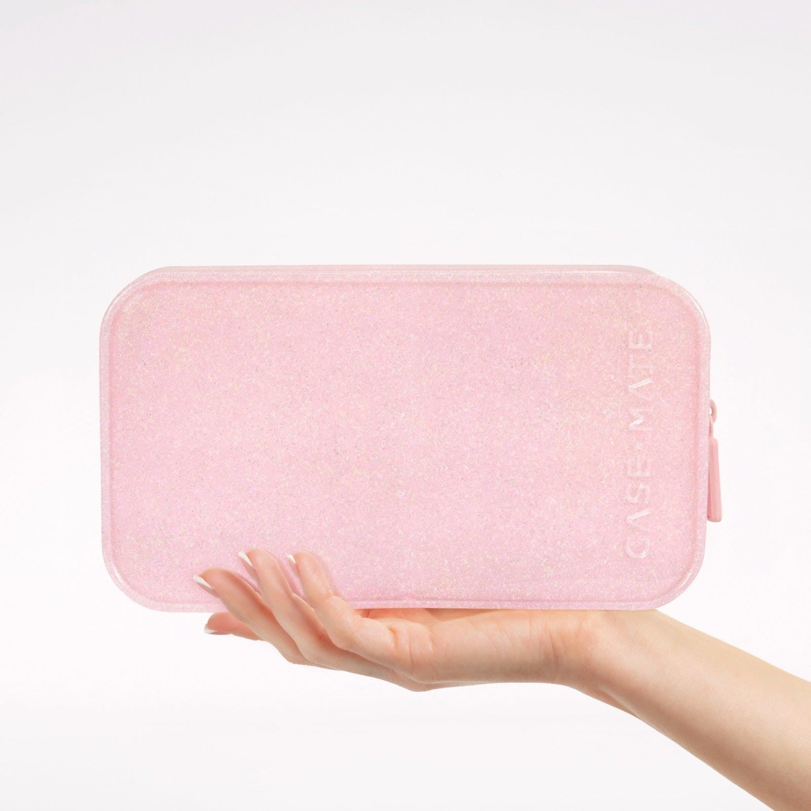 Hand holding a ballet pink twinkle glitter jelly makeup bag with a zip closure.