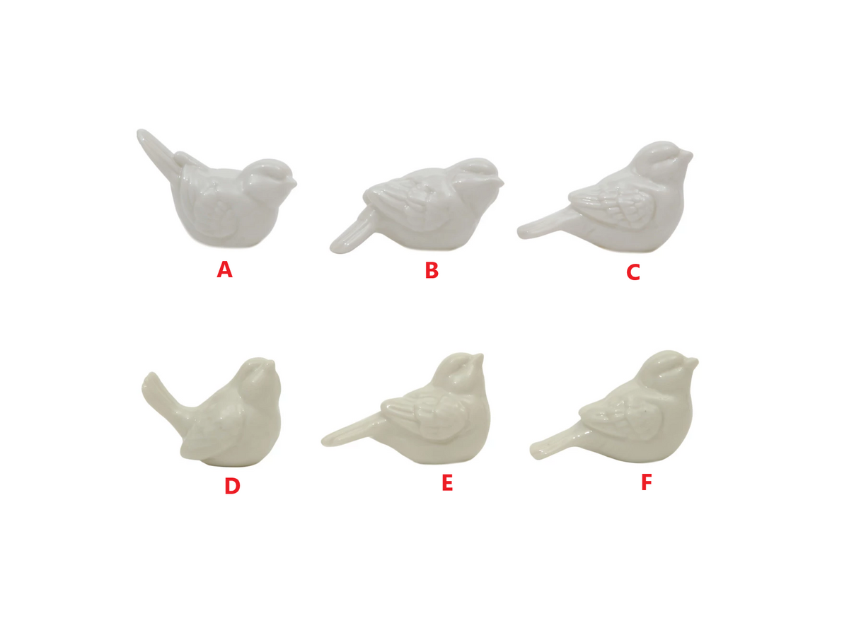 Ceramic bird figurine with a smooth matte finish in neutral tones.