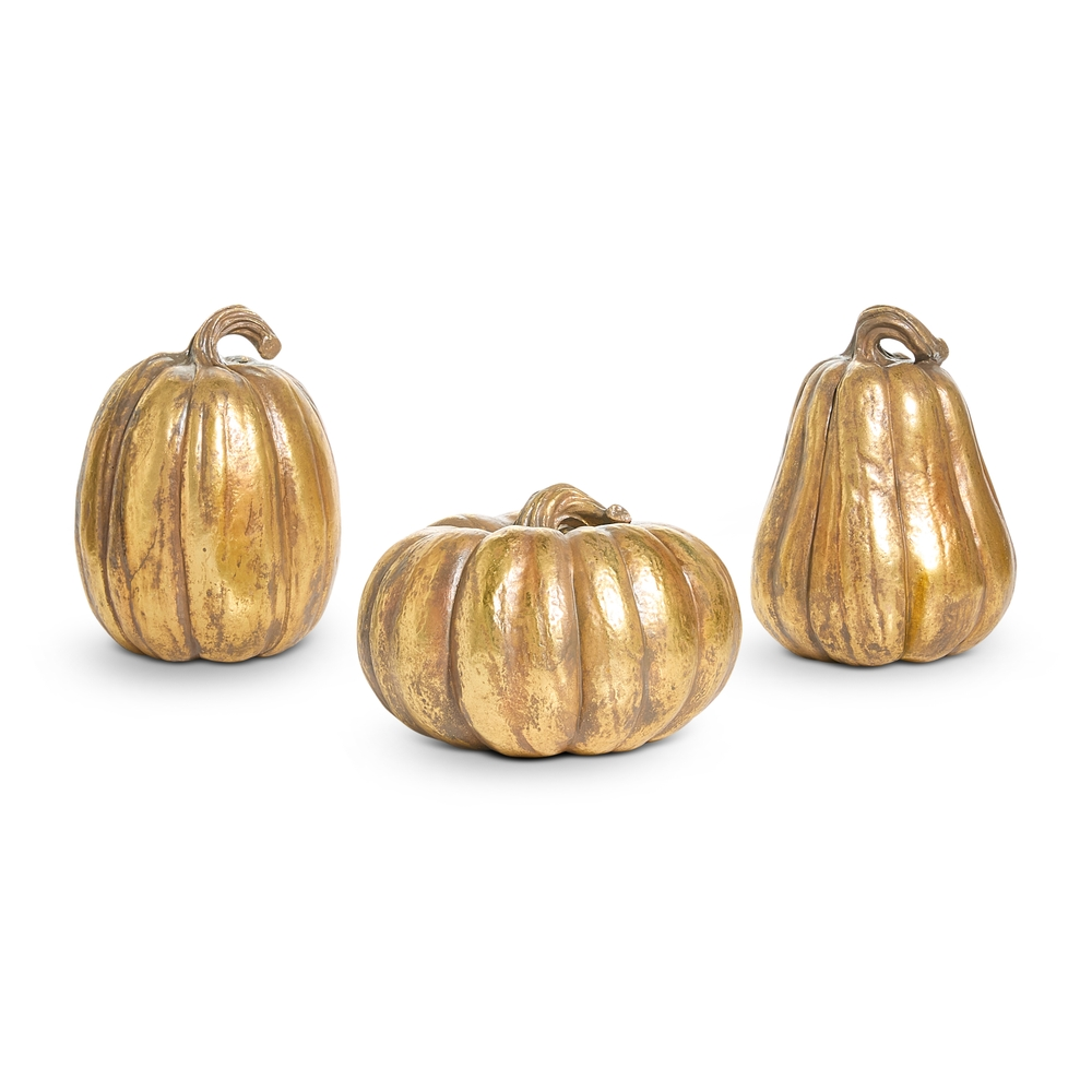 Three decorative gold resin pumpkins in various shapes and sizes with a metallic finish.