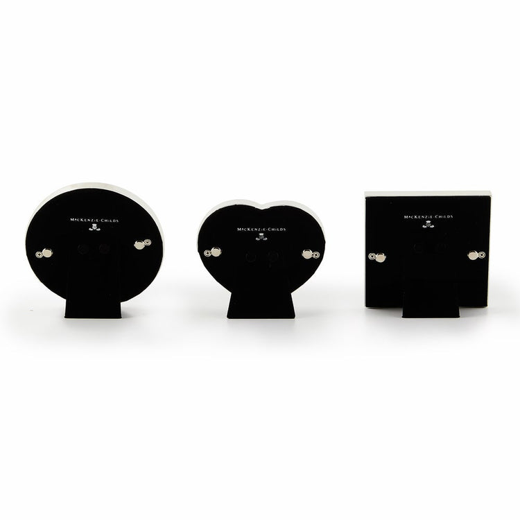 Set of three courtly frames in silver with velvet backing; heart, circle, and square shapes.