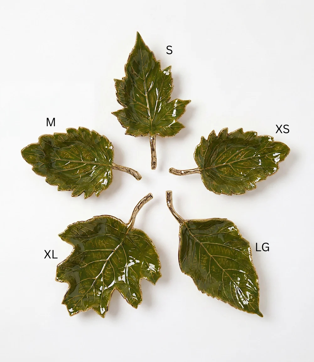 Five green enamel leaf-shaped trays in various sizes with gold metallic stems and edges.