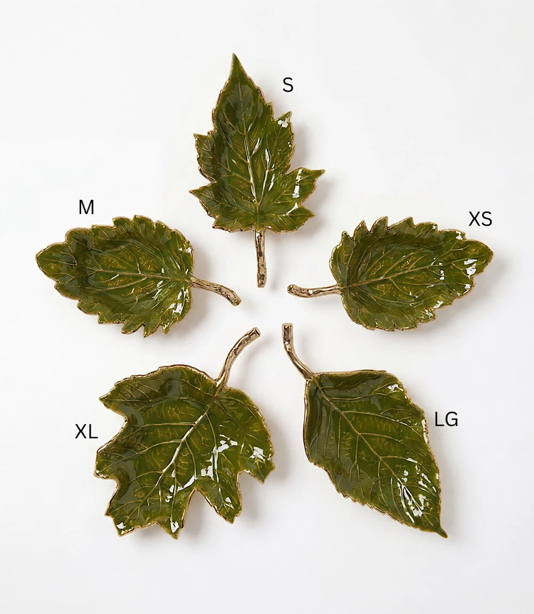 Five green enamel leaf-shaped trays in various sizes with gold metallic stems and edges.