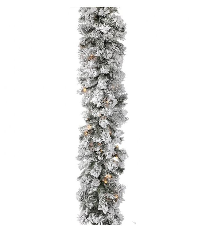 9-foot flocked furry pine garland with warm white lights and a snowy green finish.