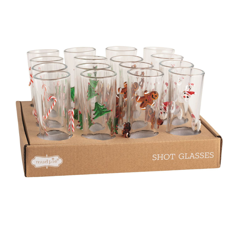 Red Christmas shot glass with white snowflake patterns on a clear base.