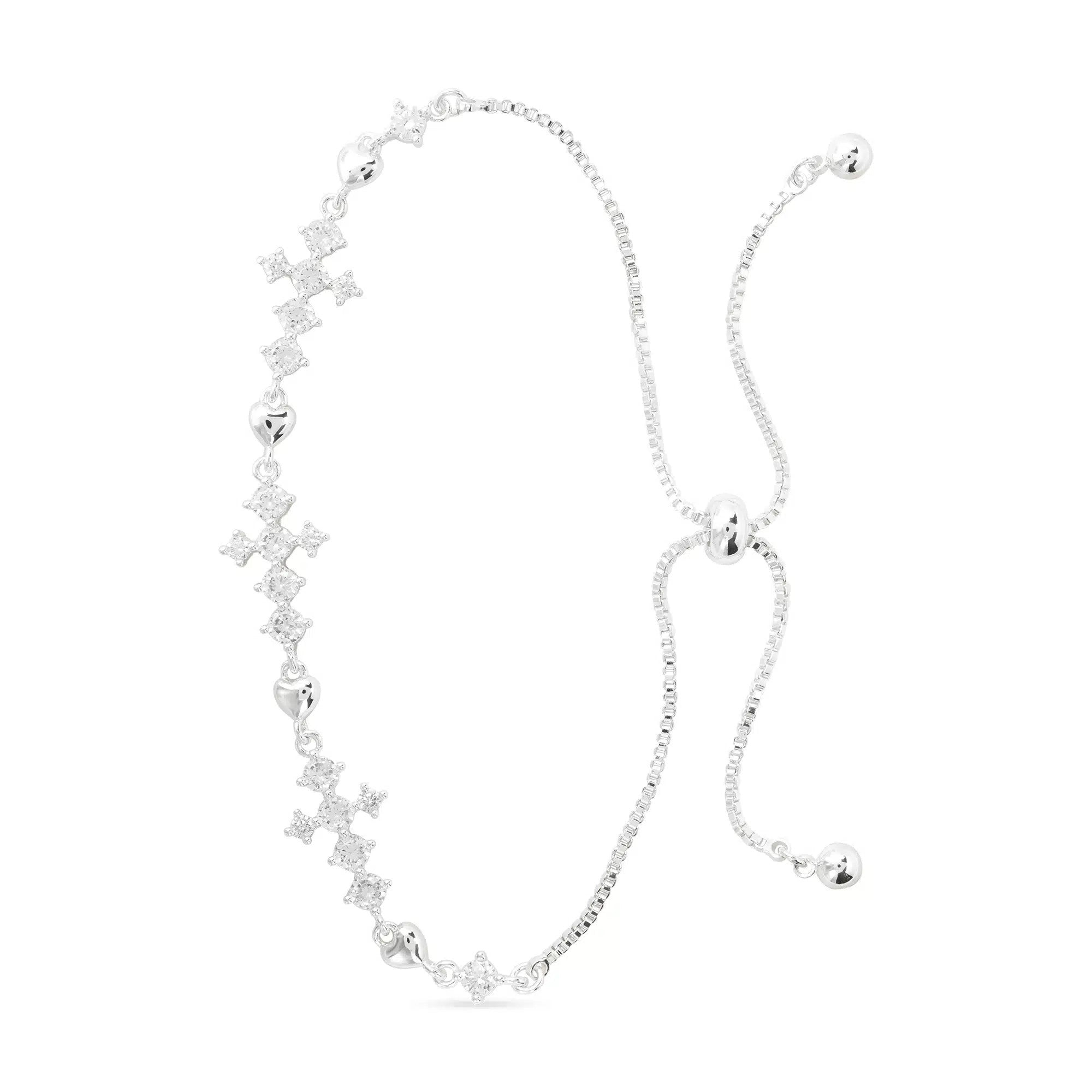 Silver pull-cord bracelet with CZ-accented cross and heart charms on a white background.