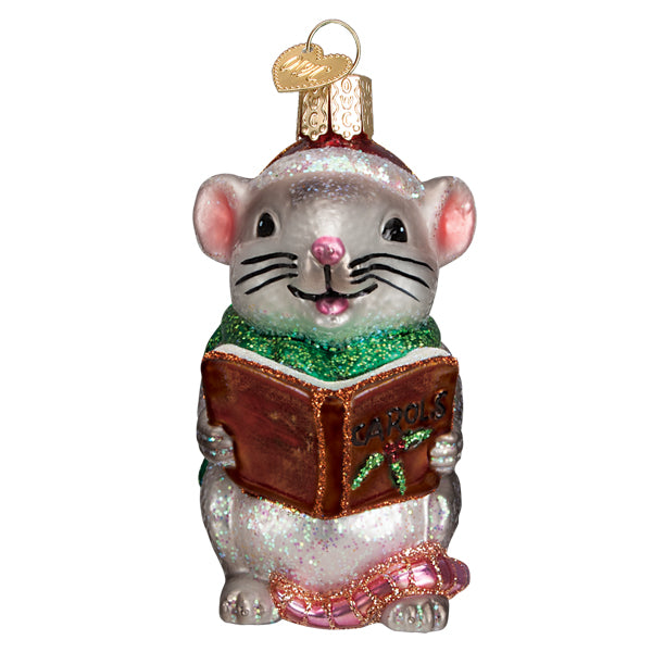 Grey glass mouse ornament wearing a Santa hat and green scarf, holding a brown carols book.