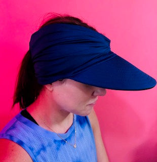 Women's open-top sun visor hat with wide brim in bright contrasting colors and elasticized chinlon fabric.