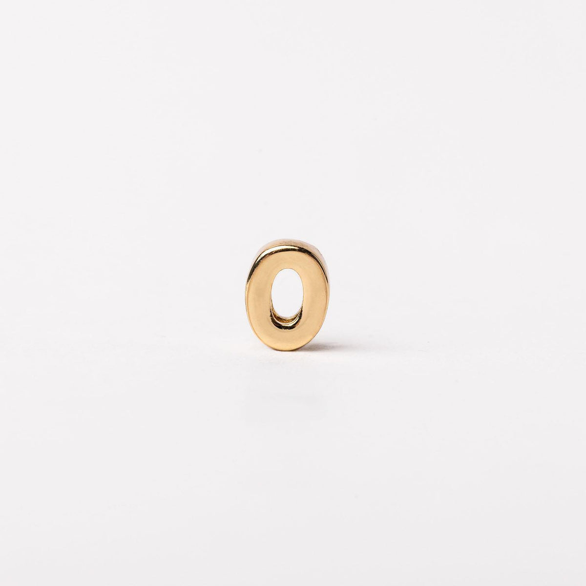 Gold-toned letter O charm with a smooth, polished finish on a white background.