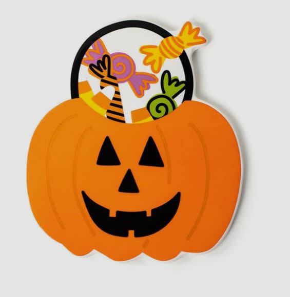 Ceramic jack-o'-lantern treat bucket attachment with colorful candy illustrations inside.