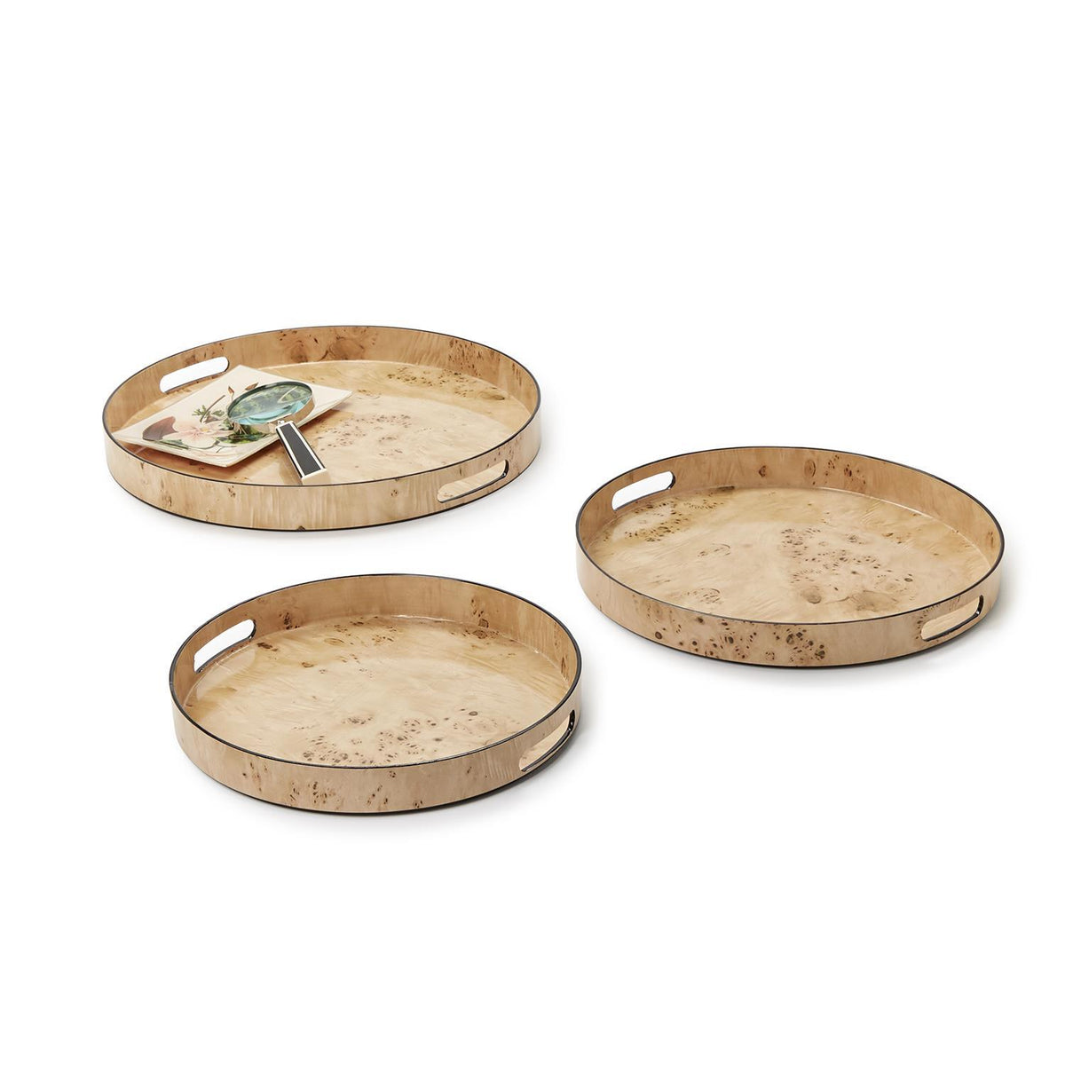 Three round trays in varying sizes featuring a light brown burled wood pattern with side handles.