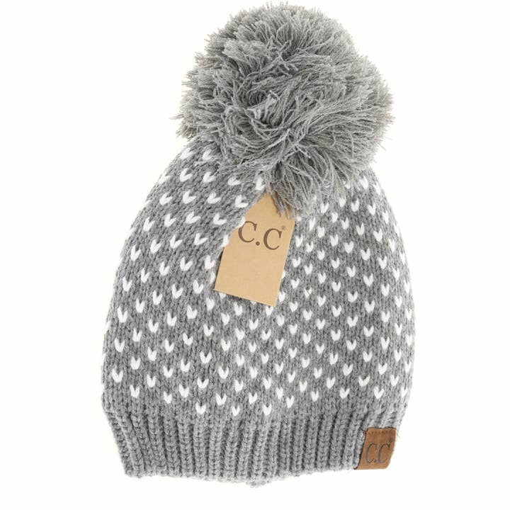 Heart Knit Pom Beanie in soft gray wool with a textured cable pattern and fluffy pom top.