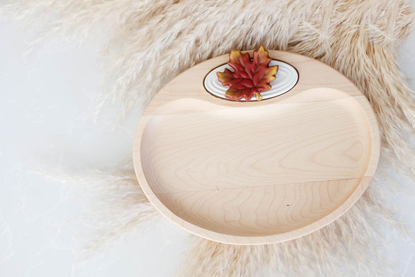 Wooden serving tray with a decorative ceramic maple leaf accent.