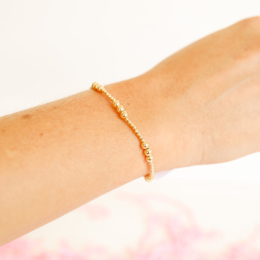 Gold basic bracelet featuring a simple chain link design with polished metal finish.