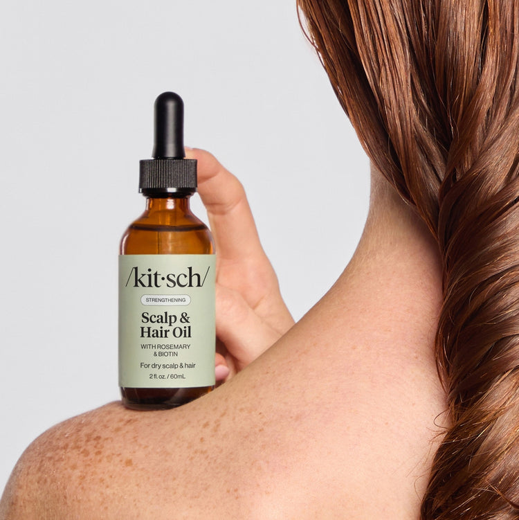 Kitsch Strengthening Scalp & Hair Oil with Rosemary and Biotin in a 2 fl. oz. amber glass bottle.