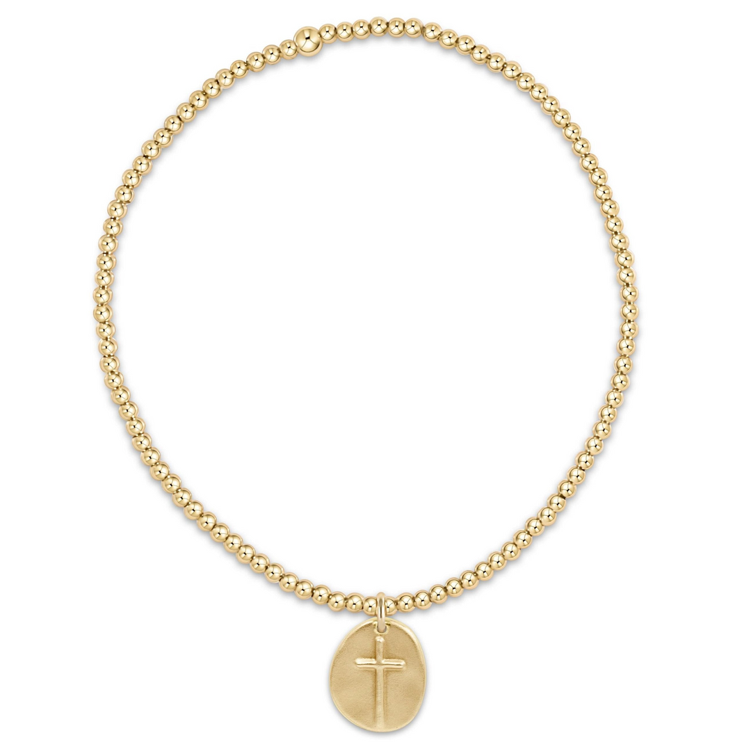 Classic Gold 2mm beaded bracelet with a small gold disc charm featuring an engraved cross.