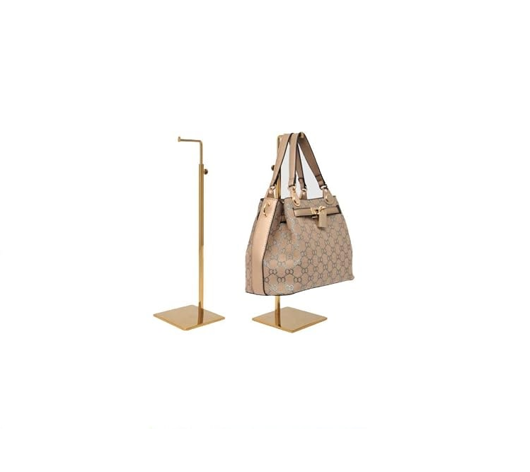 Two gold-plated adjustable handbag display stands, one shown holding a patterned tote bag.