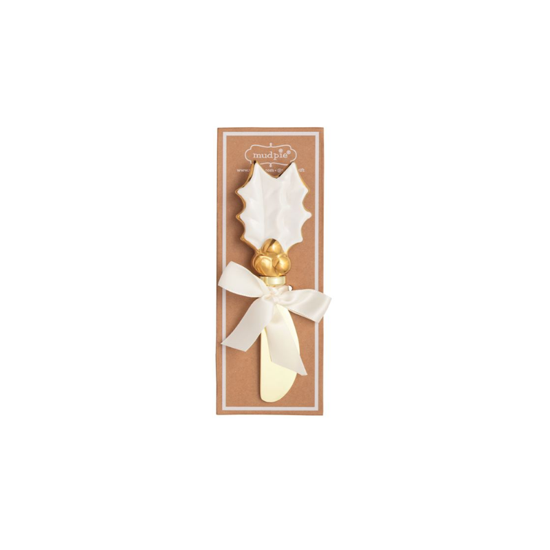Gold detail Christmas spreader with a white holly leaf stoneware handle on a brown display card.
