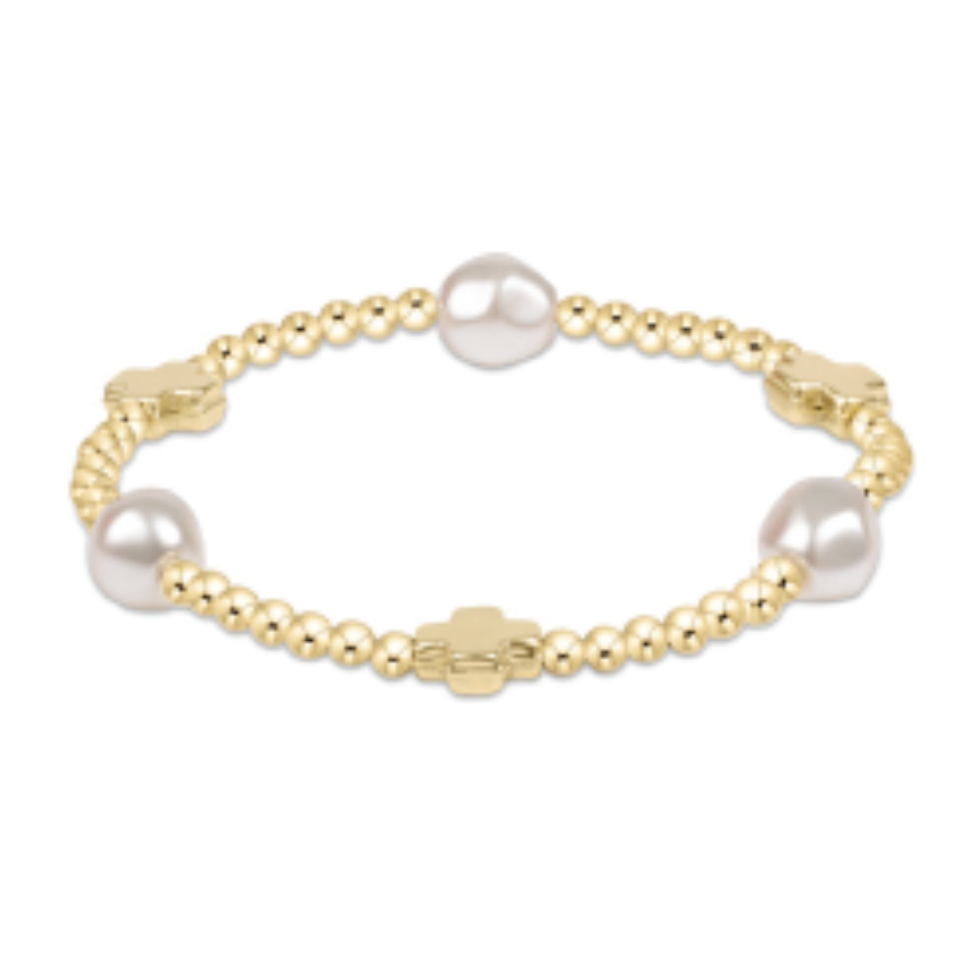 Stackable bracelet with 3mm gold-filled beads, signature cross charm, and admire pearl pattern.