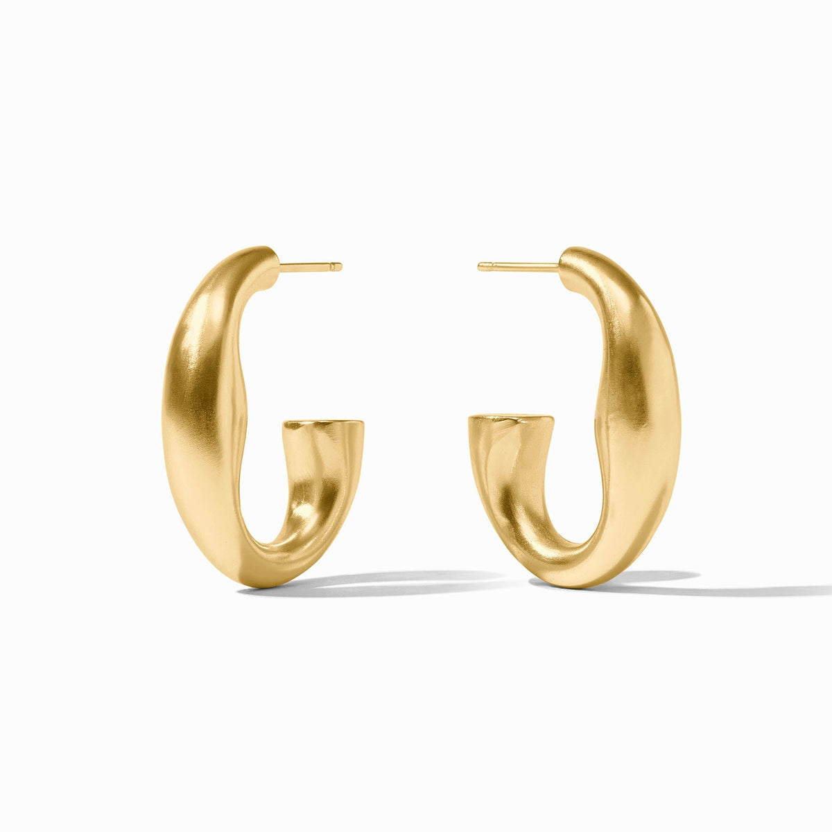 Pair of matte gold Laguna hoop earrings with a unique, curved silhouette.