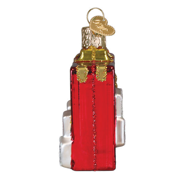 Side view of a red glass Rack N Roll Mahjong ornament with gold glitter accents and a heart charm.