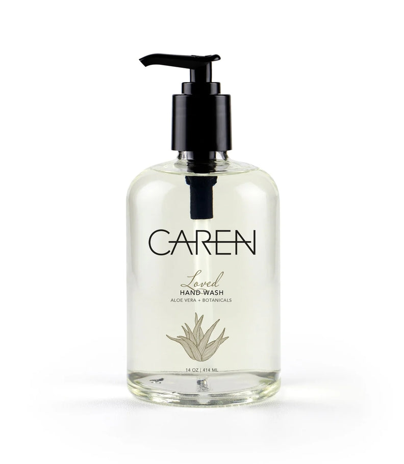 Bottle of Loved hand wash with aloe vera base in clear glass packaging.