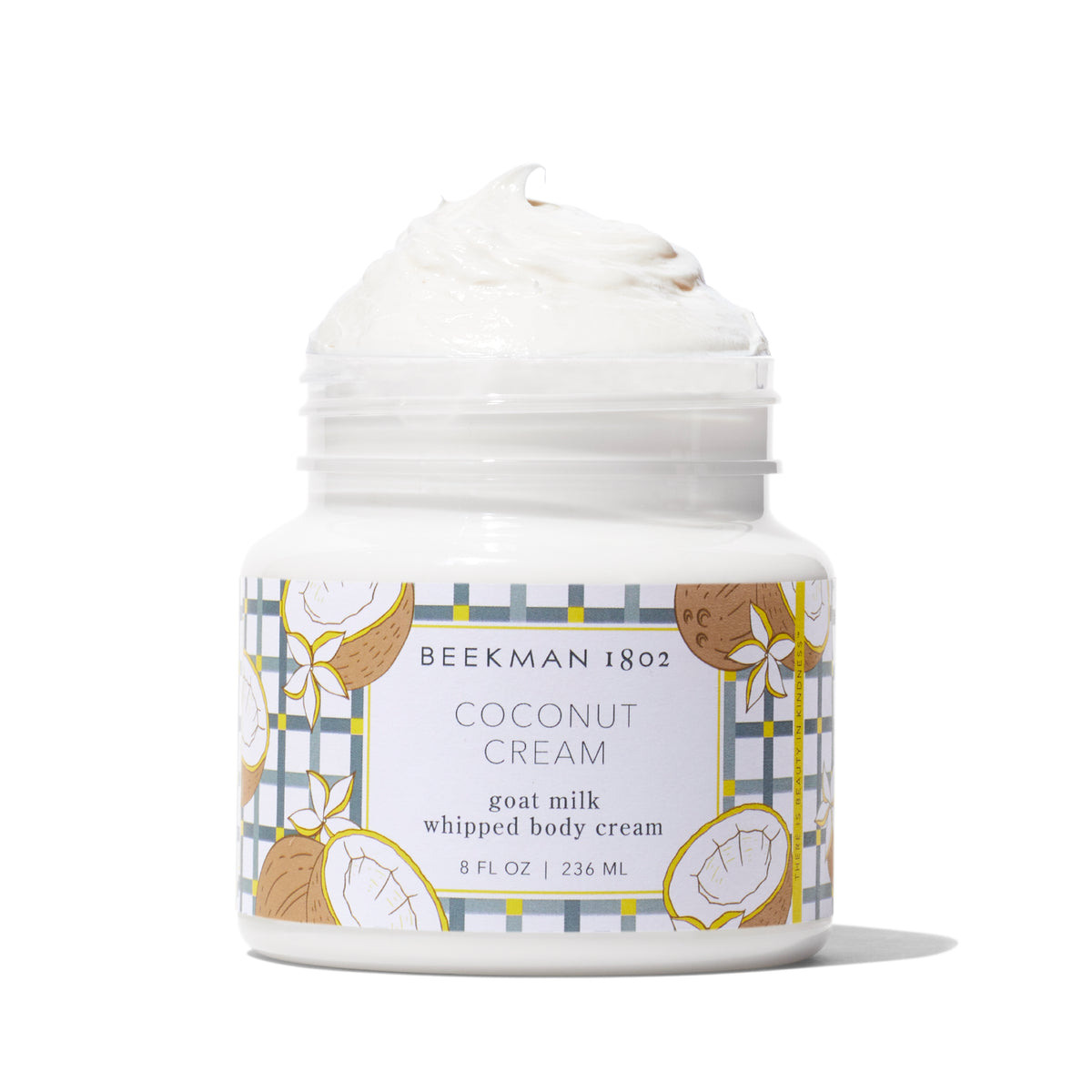 Beekman 1802 Coconut Cream goat milk whipped body cream in an open 8 oz white jar.