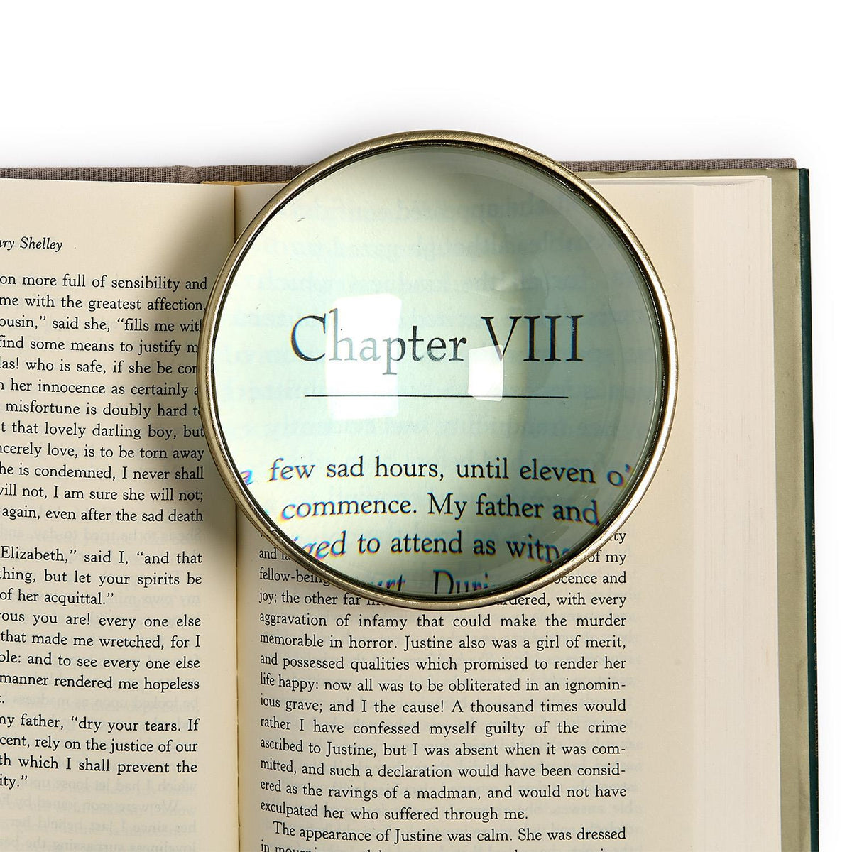 Dome Concave Lens Desk Top Magnifier with 3x magnification over a book page.