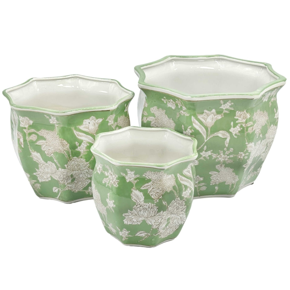 Green ceramic planter pot with white fluted rim and chinoiserie-inspired hand-painted detailing.