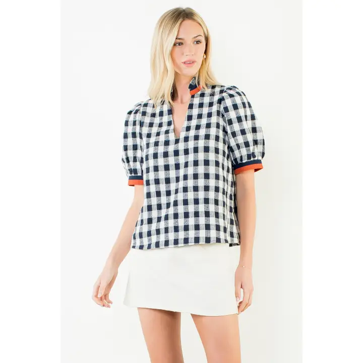 Navy blue V-neck top with puff sleeves featuring a checkered pattern