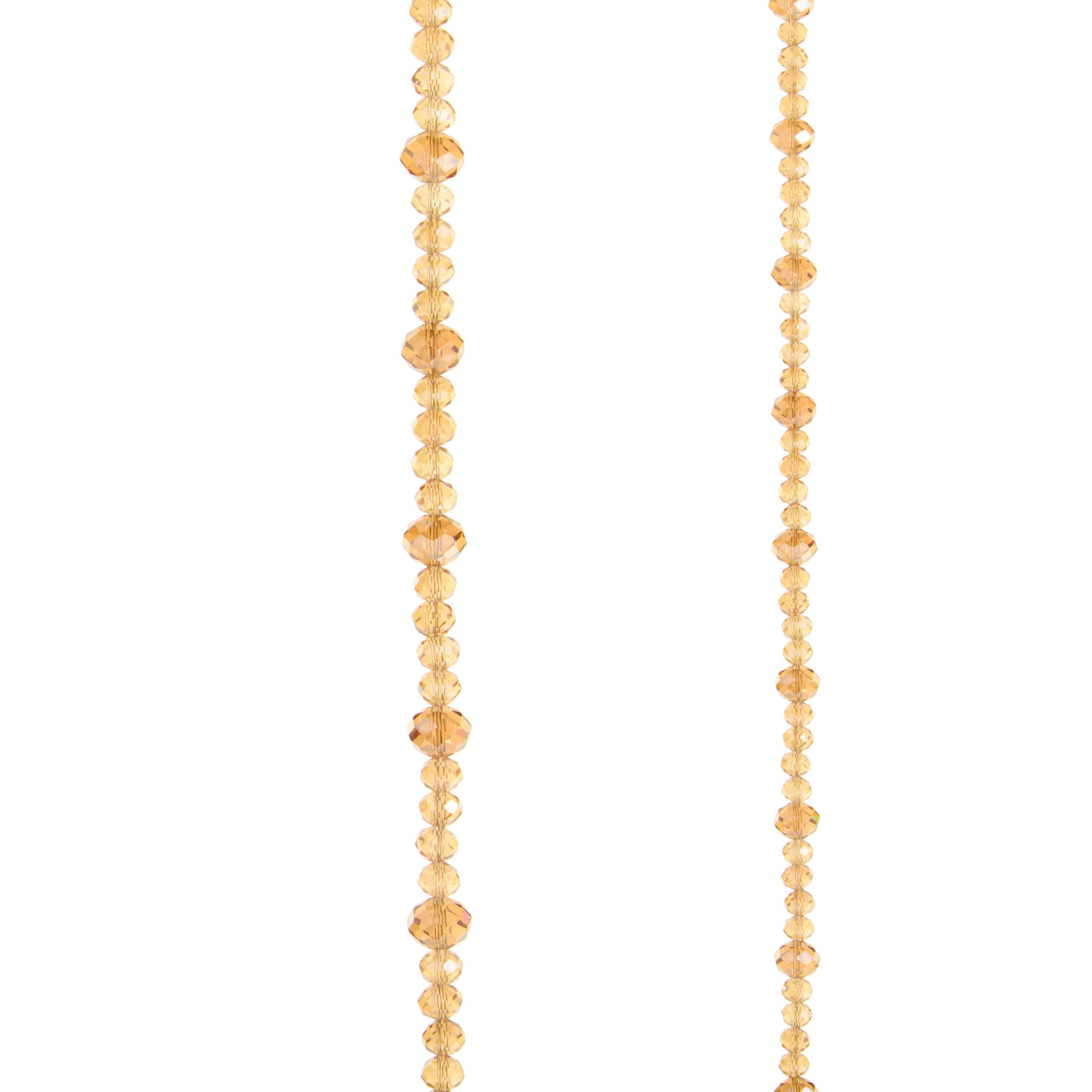 Close-up of a 6-foot champagne-colored faceted bead garland on a white background.