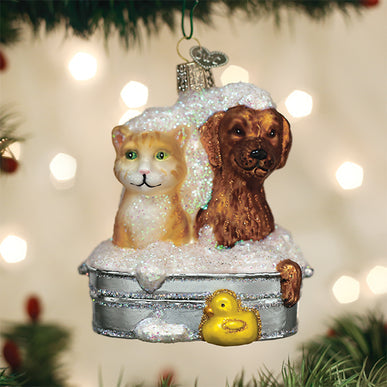 Bubble Bath Buddies glass ornament featuring a cat and dog in a sudsy tub with a yellow rubber duck.