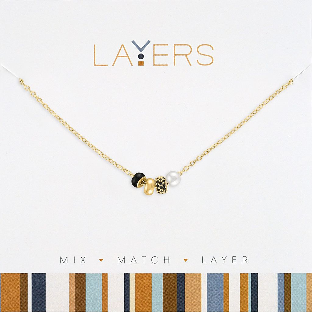 Gold chain necklace with black, gold, and textured beads alongside a white pearl.