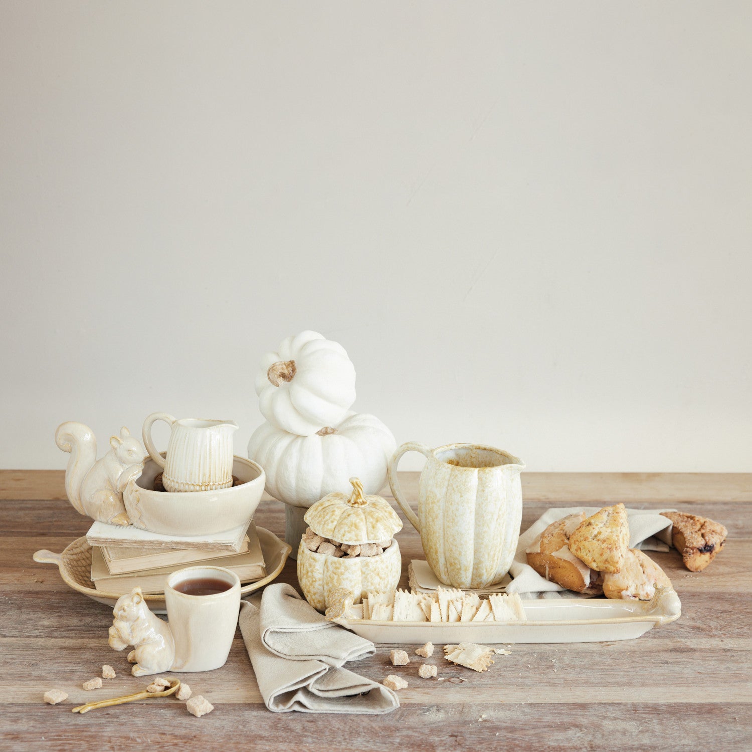 Cream stoneware bowl featuring a small squirrel figurine perched on the rim.